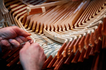 Worker wraps stator copper bus bars with insulation fabric