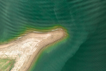 Aerial view of island surrounded by sea or ocean with clear water. Colorful landscape with beautiful nature. Tourism, traveling.