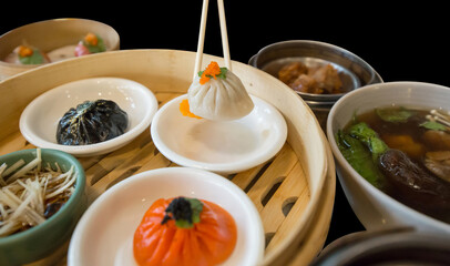 Top view of chopsticks on white Xiaolongbao and set dim sum, focus selective