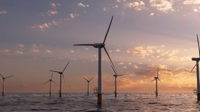 Wind Power. Offshore Wind Turbines at Sunset. Sustainable Power Concept.