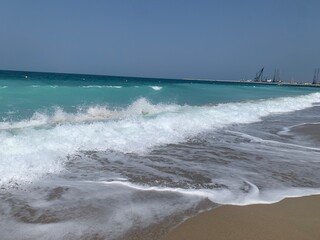 Waves on the beach of Port de la Mer in Jumeirah, Dubai