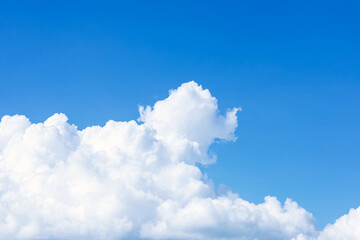 Naklejka na ściany i meble Clouds in the blue sky. Natural sky background texture, beautiful color. Peaceful blue sky with light clouds. The free form beauty of clouds and sky is perfect for background, backdrop and wallpaper.