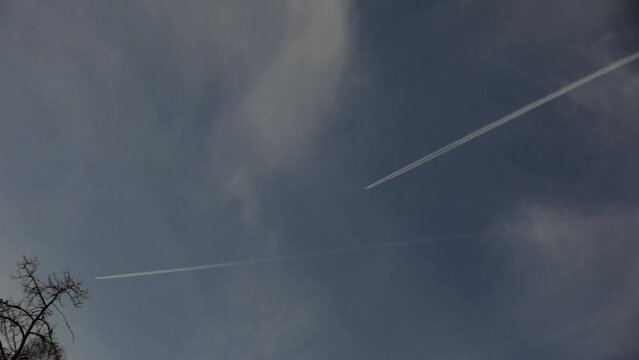 Two airplanes leaving long trails in sthe sky - in sweden