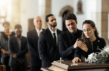 Death, funeral and family touching coffin in a church, sad and unhappy while gathering to say farewell. Church service casket and sad man and woman looking upset while greeting, goodbye and rip - obrazy, fototapety, plakaty