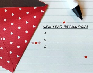 Paper letter note and envelope with text written NEW YEAR RESOLUTIONS, concept of affirmation...