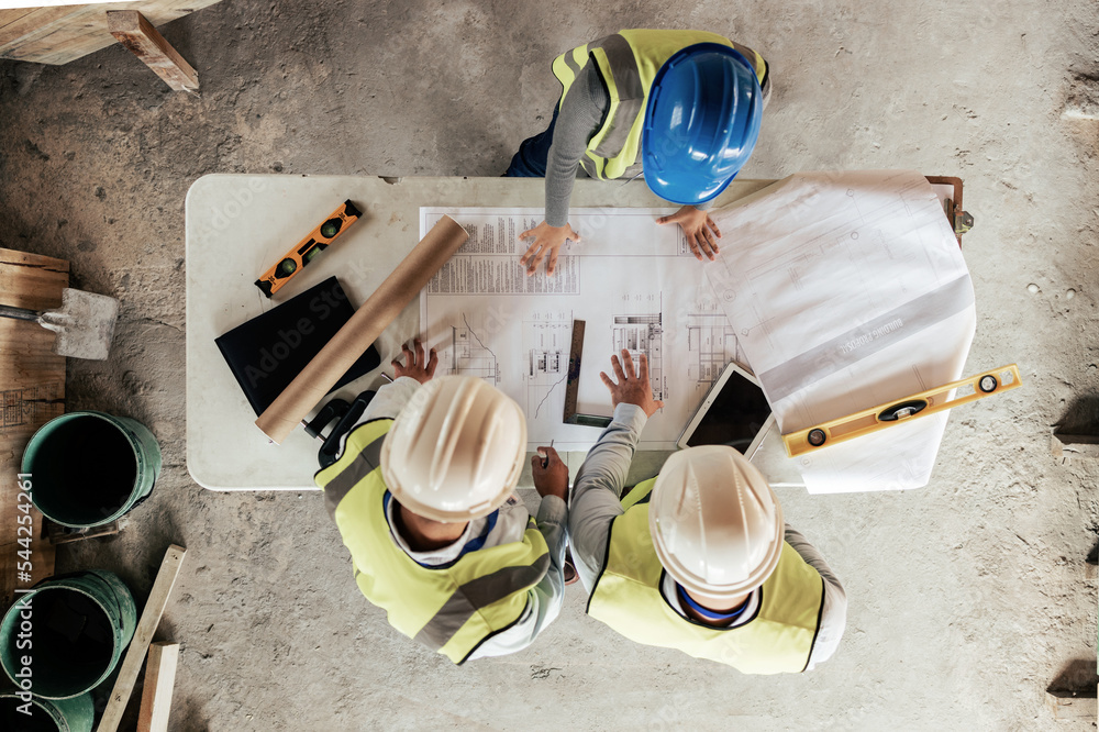 Poster Architect, construction and blueprint with an engineer and designer team working on a building site from above. Meeting, planning and architecture with a design group in collaboration on a project