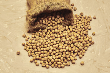 chickpeas in a canvas bag and scattered on the table