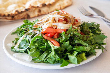 Turkish style onion arugula salad. Eruca vesicaria salad. Turkish name; roka salatasi