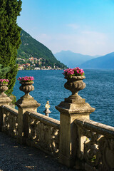 Beautiful old sculpture with flower columns in the botanical garden of the legendary Villa Monastero, located in the traditional village of Varenna, Lecco, on the shore of Lake Como, Italy.