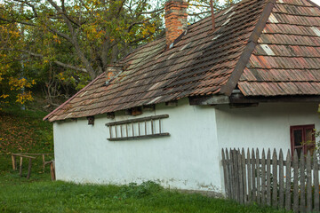 Old peasant house in autumn season.