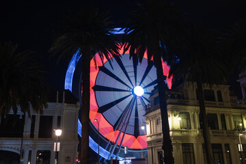 Bright lights in the night city Ferris wheel on long exposure.