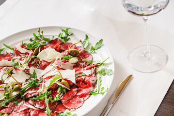 beef carpaccio with cheese and arugula