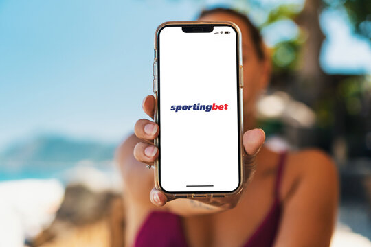 Girl on the beach holding a smartphone with Sportingbet betting provider app on the screen. Rio de Janeiro, RJ, Brazil. November 2022