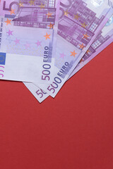 500 euro banknotes on a red background close up