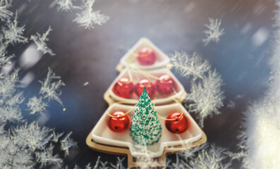 Abstract Christmas background. Frozen postcard with decoration in the shape of a Christmas tree and balls.