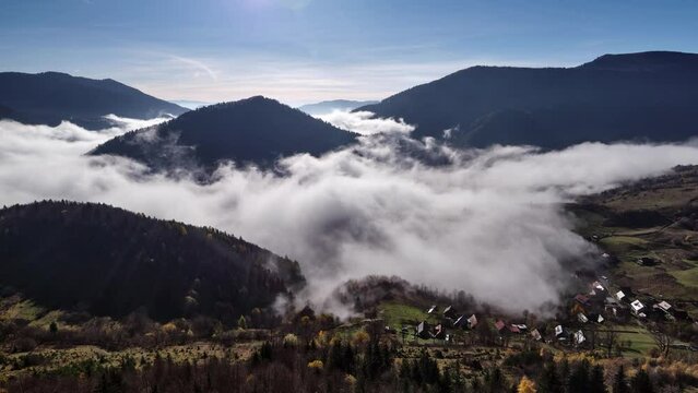 Rural hilly landscape shrouded in fog of low clouds