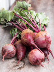 red edible beetroot top view on a wooden background