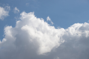 Blue sky background with white clouds.