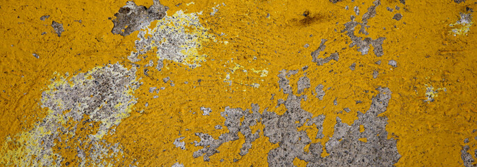 peeled yellow painted stone wall 