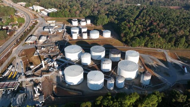 Aerial of tanks at fuel terminal. Trucks load with chemicals. Large big oil theme.