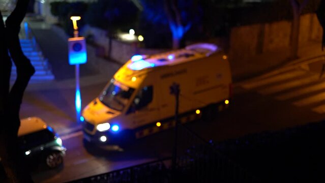 Blurred video of an ambulance in a night city.