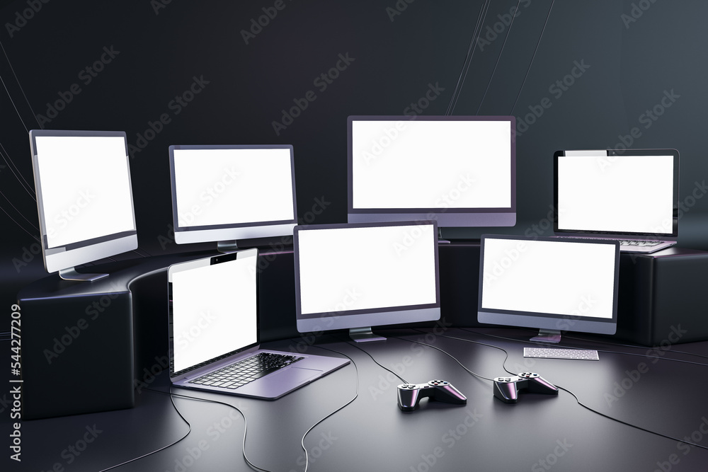 Poster Blank white monitors of modern computers and laptops with blank space in home game studio with dark wall and joysticks on glossy surface, streaming videogames and gaming concept. 3D rendering, mock up