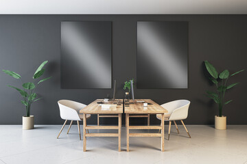 Modern coworking interior with empty black mock up screen on dark wall, desk, computer, chairs, decorative items, plants and supplies. Mock up, 3D Rendering.