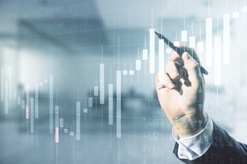 Man hand with pen working with abstract virtual financial graph on blurred office background, financial and trading concept. Multiexposure