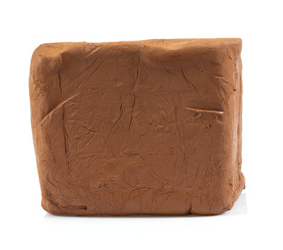 Natural clay piece isolated on white background. Wet clay material for sculpting or modeling.