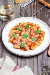 Gnocchi with tomato sauce, basil and Parmesan cheese. Healthy eating. Vegetarian food. Diet.