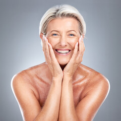 Skincare, smile and senior woman with a glow from dermatology against a grey studio background. Happy, smile and wellness face portrait of an elderly model with happiness for beauty and cosmetics