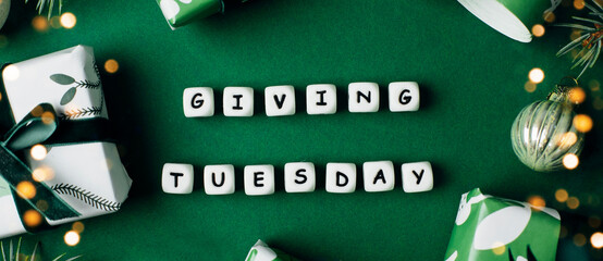 Giving Tuesday concept. Gift Wrapping Boxes, fir tree on green background. Charity, give help, donations support concept. Top view, flat lay. Banner for web site - 544286261