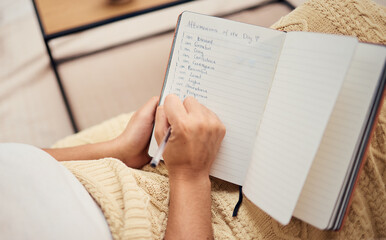 Book, hand and woman writing list in her notebook while relaxing with ideas and future vision. Self...