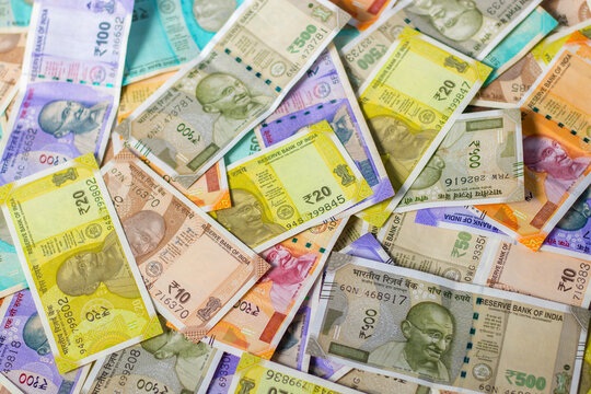 Indian currency notes are scattering on the floor. 