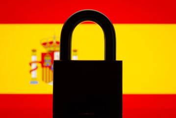Silhouette of lock with flag of Spain on the background. Concept of closed borders of country...