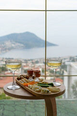 White wine and cheese plate with sea view