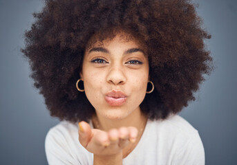 Face, portrait and woman blowing a kiss on a grey studio background being flirty and seductive. Fun, flirting and beautiful african american female kissing and being alluring and isolated on backdrop - obrazy, fototapety, plakaty
