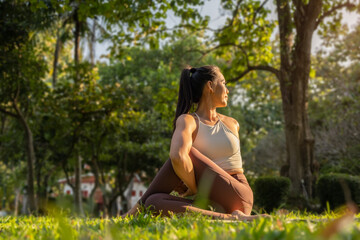 Naklejka na ściany i meble Peaceful woman practicing yoga on the background of nature. Yoga, pilates, healthy lifestyle concept.