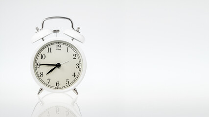 white retro alarm clock on a white background with space for any text