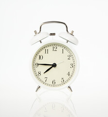 white retro alarm clock on white background