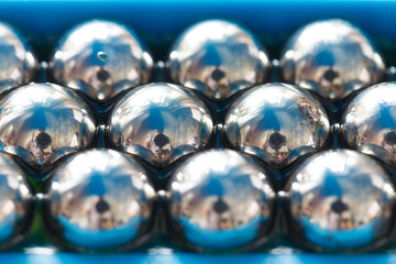 Metal balls close-up in blue tones.