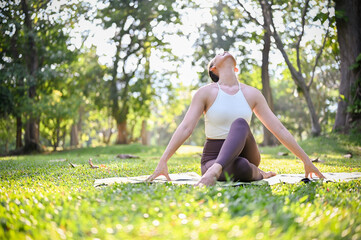Attractive Asian woman practicing Lotus pose or knee pile pose and stretching her neck up
