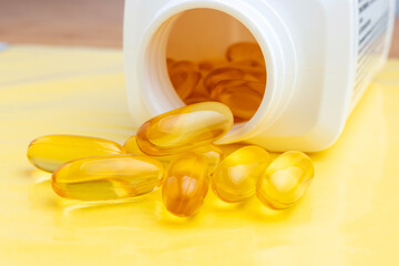 Yellow capsules of omega-3, fatty acid, nutritional supplement pills