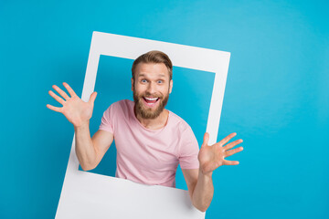 Photo portrait of attractive young man cheerful jazz arms social media post frame wear trendy pink outfit isolated on cyan color background