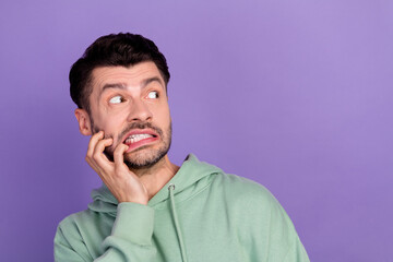 Closeup photo of young funny excited nervous student man wear khaki hoodie bite fingers look...