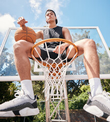 Sports, basketball and man sitting on basketball hoop and preparing for training, match or...