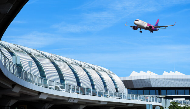 Hungary, Budapest - October 10, 2022: Passenger airplane over the building of International Ferenc Liszt Airport of Budapest. Hungarian low cost company Wizz Air aircraft landing to the Terminal 2A.