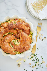 Flay lay close-up of Christmas breakfast with croissants and ham and cheese baked in the oven.