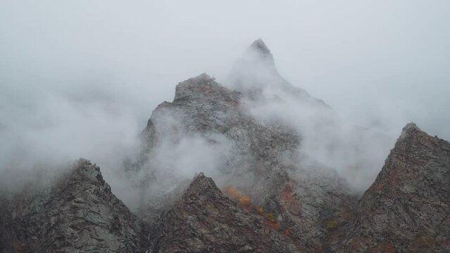 4K shot of clouds above the mountain peaks during the storm at Jispa in Lahaul Spiti district at Himachal Pradesh in India. Clouds covers the peaks of the mountains. Natural background.	