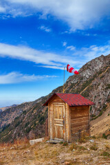 House in the mountains with a weather vane to indicate the direction of the wind - 544307476